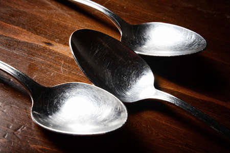 old used cutlery  on dark wooden tableの写真素材