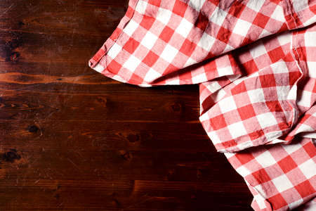 top view of checkered napkin on wooden tableの写真素材