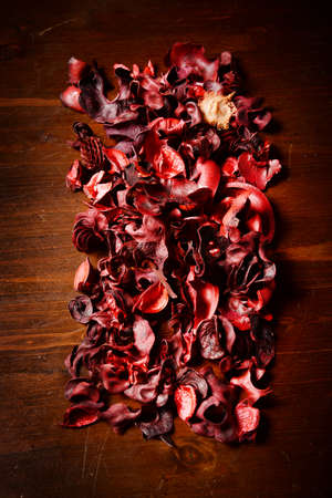 red scented potpourri  on dark wooden tableの写真素材