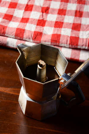 top view of checkered napkin on wooden table with red coffee cup and  vintage coffeepotの写真素材