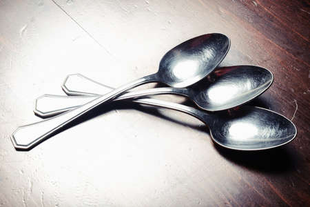 old used cutlery  on dark wooden tableの写真素材