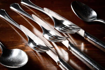 old used cutlery  on dark wooden table