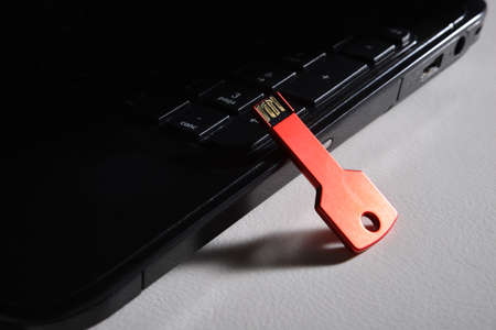 red usb key on black keyboard