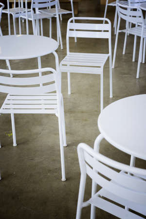 rows of white wooden chairの写真素材