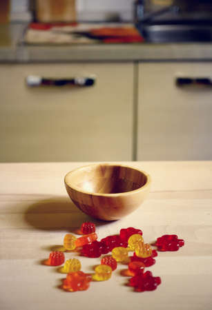 colorful Gummy Bear Candy on wooden table on kitchen  backgroundの写真素材