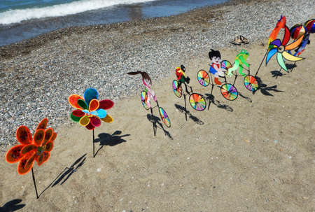 colorful pinwheels on the beach