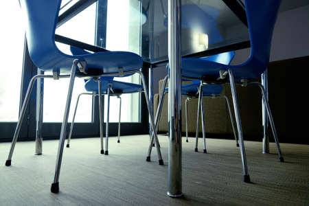 blue chairs around a tableの写真素材