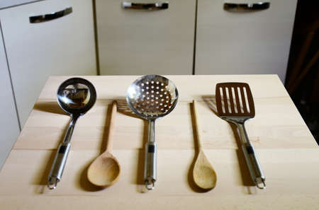 ladles on wooden table on kitchen  background