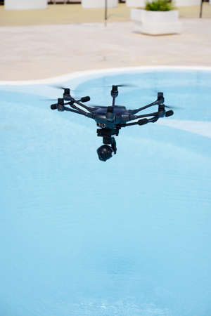 drone hovering over swimming poolの写真素材