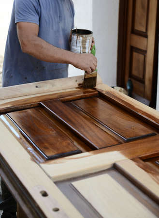 carpenter painting a wood doorの写真素材