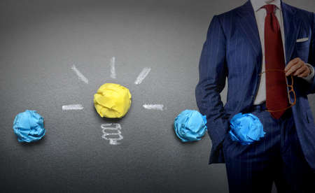 light-bulb-crumpled-paper-and bisinessman-idea-concept-backgroundの写真素材