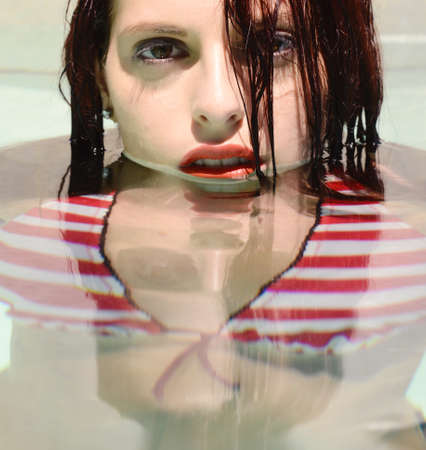 beautiful happy woman portrait in  the poolの写真素材