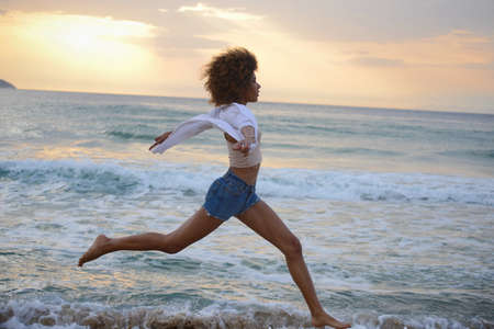 beautiful woman portrait in fashion swimsuit at sunset on the seaの写真素材