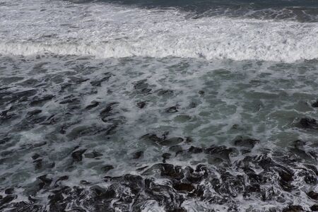 Water swapping over the rocksの写真素材