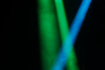 abstract background with green and blue bokeh defocused lightsの写真素材