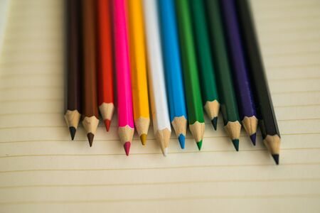 Color pencils on white notebook background.Close up.の写真素材
