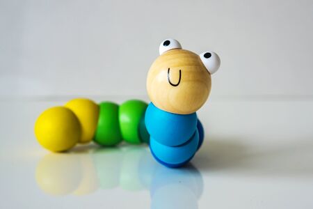 Closeup of wood, colorful, kids, toy caterpillar on the white background, suitable for babies and...