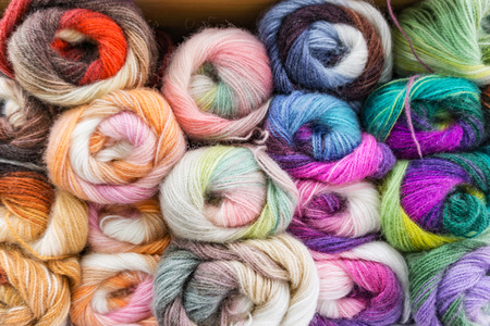 Closeup of colored mohair melange yarn for knitting, skeins in white, purple, pink, blue, red, yellow,ect. background, texture. Hobby concept.の写真素材