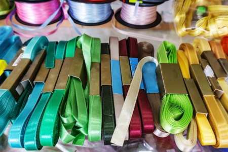 Yarn store, Passemanterie. Rolls with colorful ribbons white, green, blue and red.の写真素材