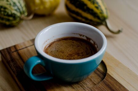 Close up blue cup with cezve coffee on a woodwn table.の写真素材