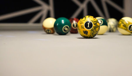 Yellow Billiard Ball with the Number One on a Gray Billiard Table Background. Recreation, Leisure,...
