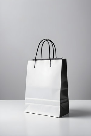 Black and white paper shopping bags on white background. Mock up.の素材