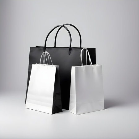 Black and white paper shopping bags on a gray background. 3d rendering.の素材
