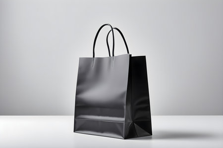 Black paper bag mockup on white background. 3d rendering.の素材