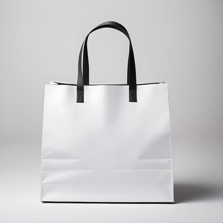 Blank white shopping bag mockup isolated on grey background. 3d renderingの素材