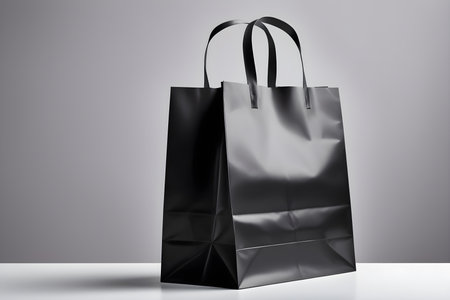 Black paper shopping bag on a gray background. 3d rendering.の素材