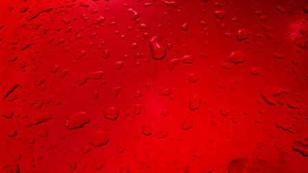 Water Drops background on the red glossy surface, Rain droplets on red textureの写真素材