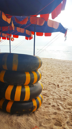 AUGUST 3, 2018:  Life ring on the sand and umbrella on beach, Beautiful sea view background at Cha-am, Thailandのeditorial素材