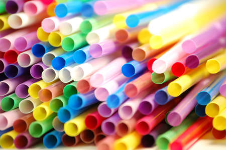 many color cocktail straws isolated on whiteの写真素材