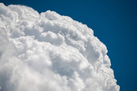 White fluffy cloud on a sunny day in the blue sky
