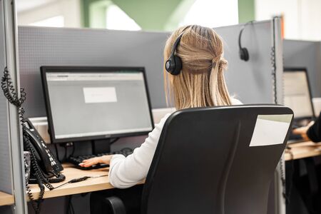 girl with a head phone works in a call center. work as an assistant in working with applications. anonymous helpの写真素材