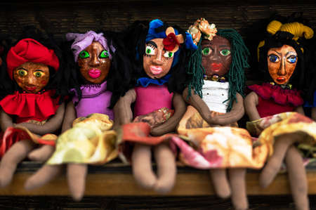 A row of handmade dark-skinned dolls. Baby toys in the form of girlsの写真素材