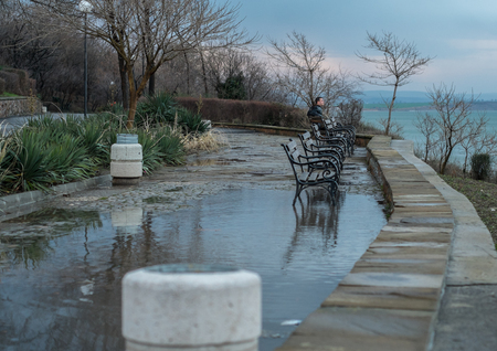 Man Sits on the Waterfrontの写真素材