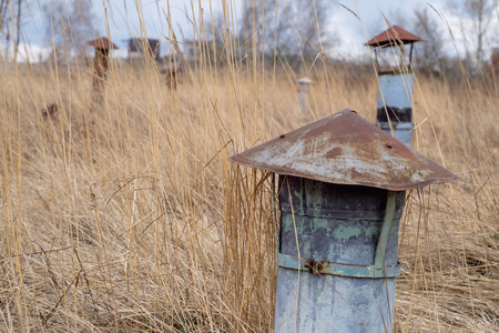 Rusty pipe on field background