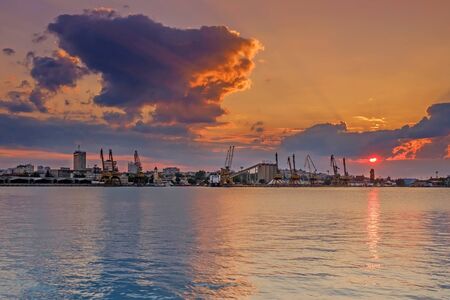 Orange sunset over city portの写真素材