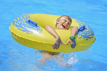 Child plays on a yellow rubber ring