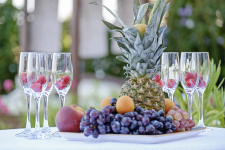 Exotic fruits and champagne glasses with berries on the table 2の写真素材