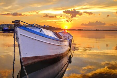 Fishing boat at black sea in orange incredibly beautiful sunset 1の写真素材