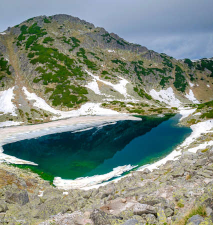 Frozen Clear Emerald Lake in the Mountainsの写真素材