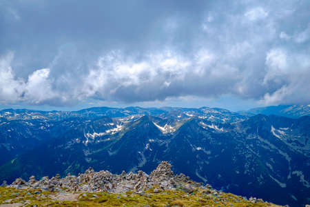 Snow-Capped Mountain Peaks with Mystic Foggy Cloudsの写真素材