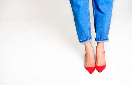 female legs in red shoes. Women's shoes on a white background.shoes that should not be wornの写真素材