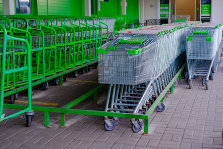 parking for shopping baskets. shopping in the supermarket. parked baskets.empty parking lot. baskets of different sizes. Shopping Baskets for Products in supermarketの写真素材