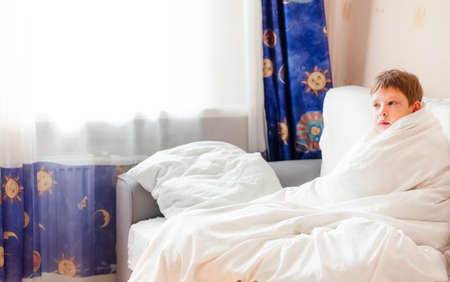 child in bed. sick child in bed. Children's day regimen. Morning getting to school. cold batteriesの写真素材
