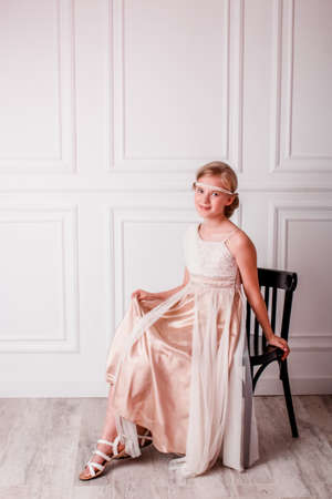girl in a white dress. girl in the Greek style. hairstyle in the Greek style for long hair. Gentle photo of a girlの写真素材