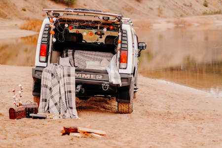 Russia, Kazan-october 16, 2019: white jeep on the sand. Nicely designed car for a photo shoot. White hummer on the lakeのeditorial素材