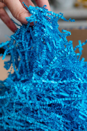 blue background. volumetric texture. Paper filler. Filler for gifts. for a paper party. For gift wrappingの写真素材